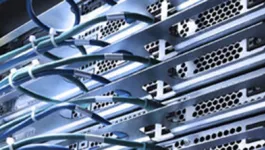 Wires plugged in to the back of a computer server