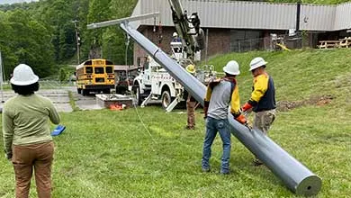 lineman installing composite utility pole