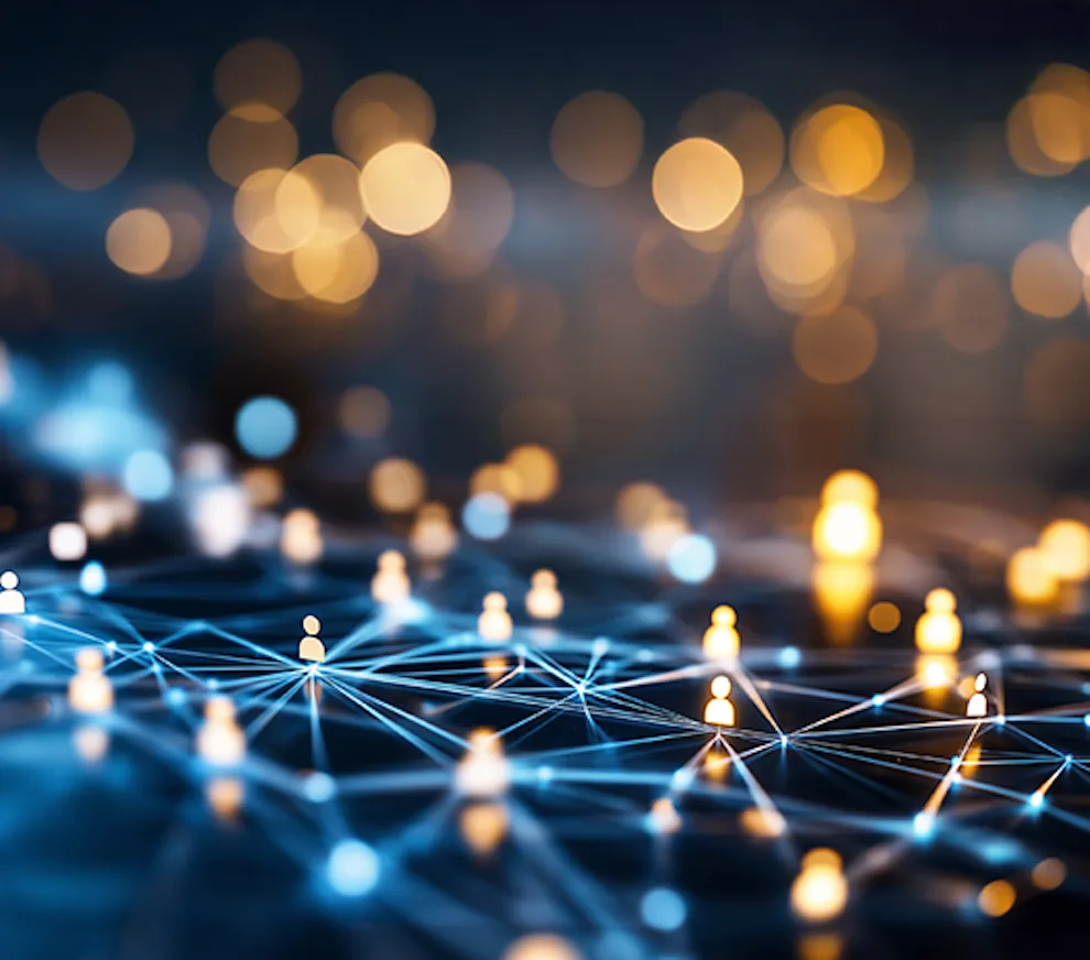Abstract digital image showing small glowing person icons connected by bright blue lines on a dark background, with large blurred golden lights in the distance.